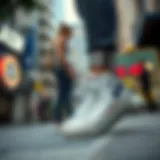 Stylish white high-top Converse shoes on a city street
