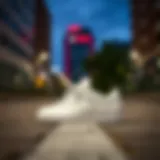 Stylish Hummel white sports shoes on a urban background